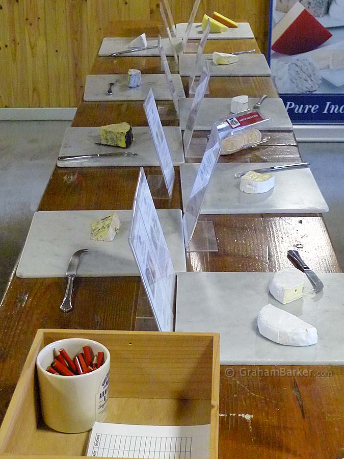 Cheese laid out for tasting - with scorecards, pencils, crackers and water. King Island Dairy, Tasmania