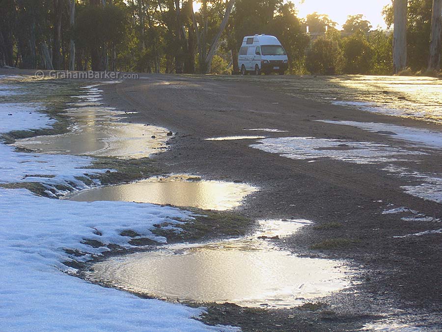 Remnant snow and frozen puddles at Pumphouse Bay campground, Tasmania