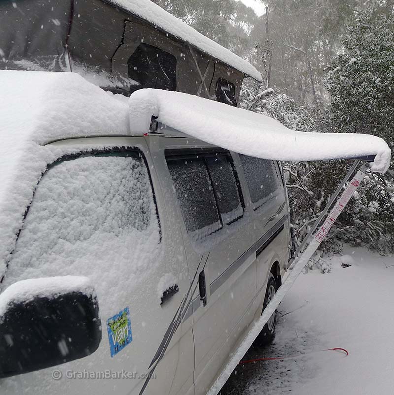 Campervan in snow at Cradle Mountain campground, Tasmania